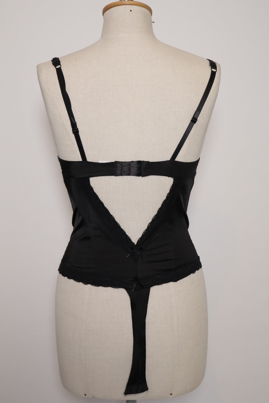 Black bustier with red stripes, open back and corset details on the sides