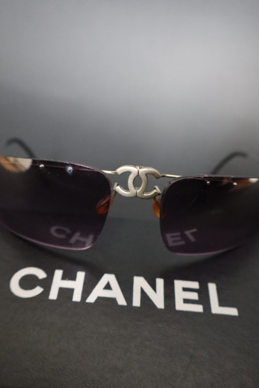 Chanel CC logo folding rimless wrap sunglasses with purple lenses
