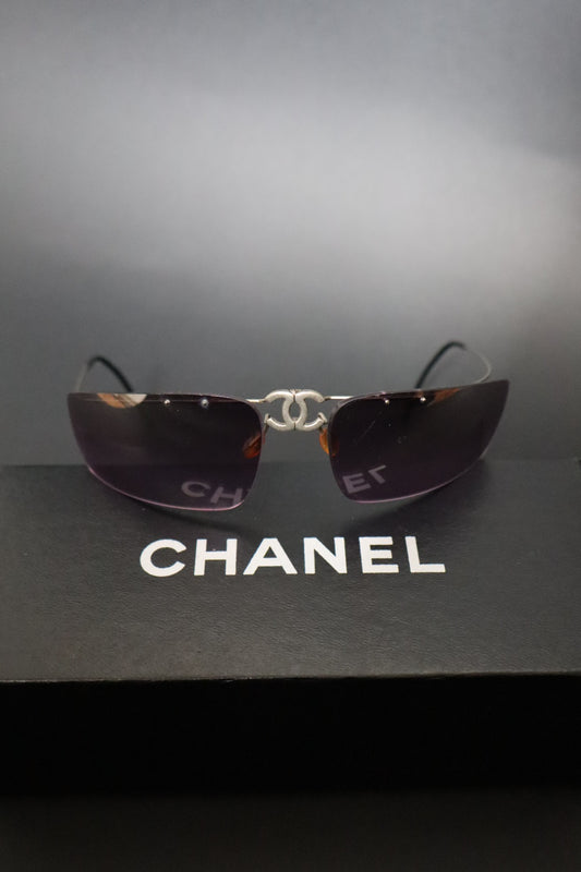 Chanel CC logo folding rimless wrap sunglasses with purple lenses