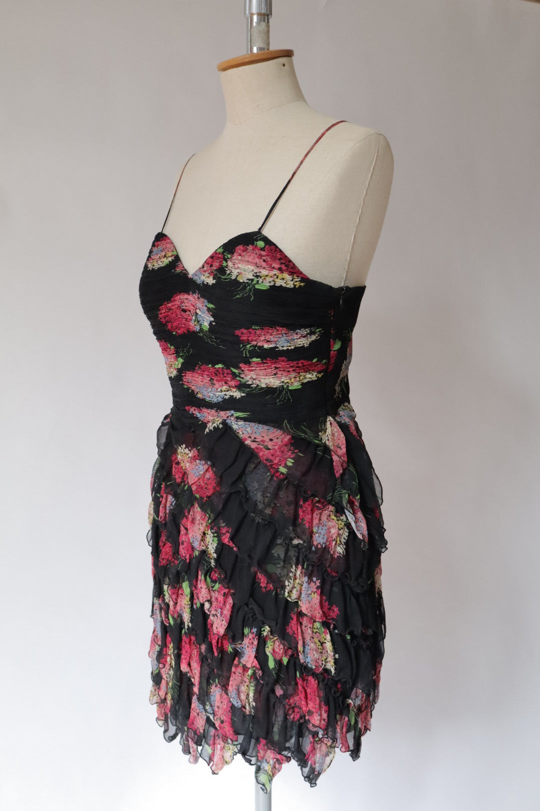 100% silk dress with flower print and ruffles. Size M