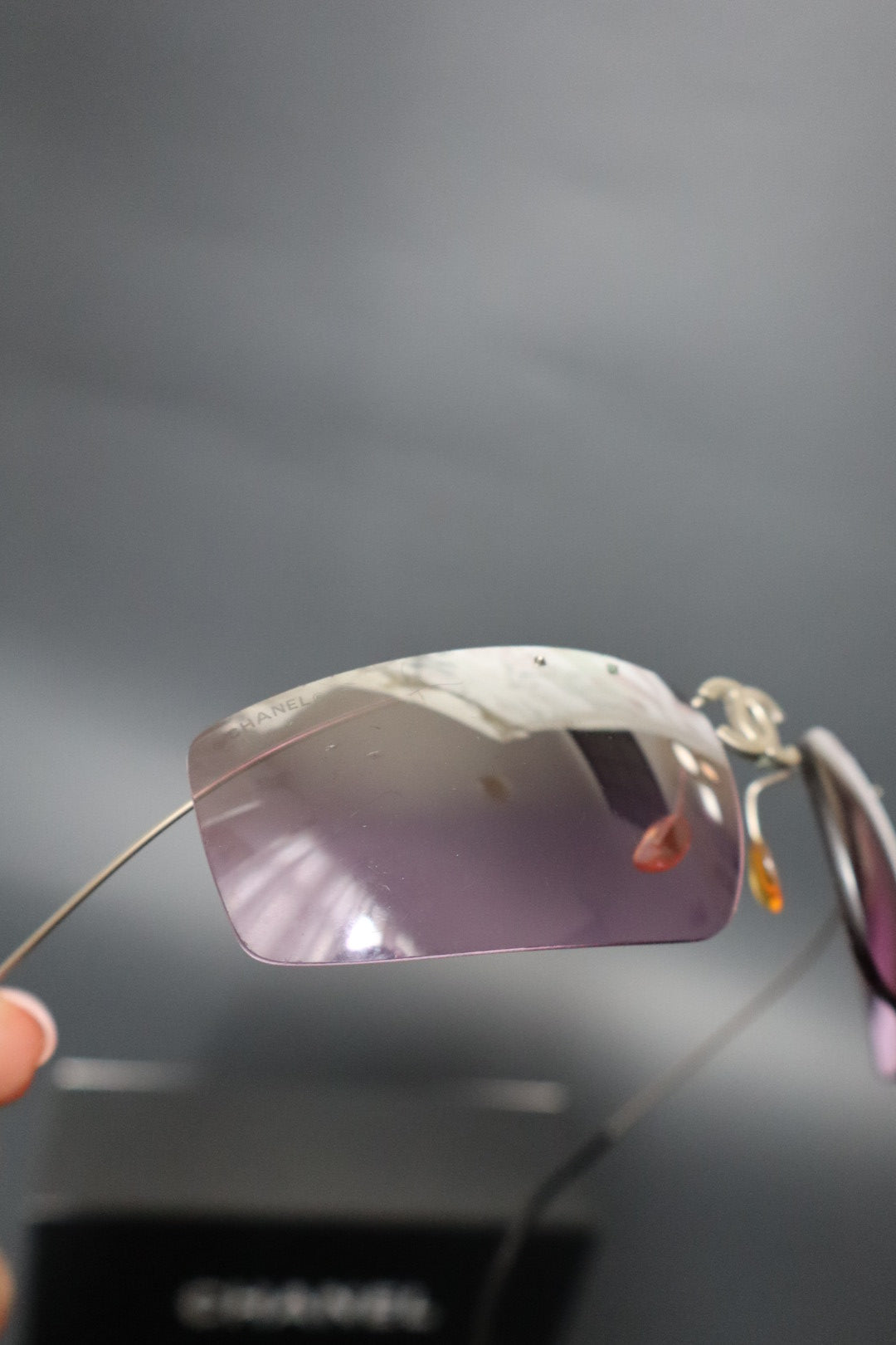 Chanel CC logo folding rimless wrap sunglasses with purple lenses
