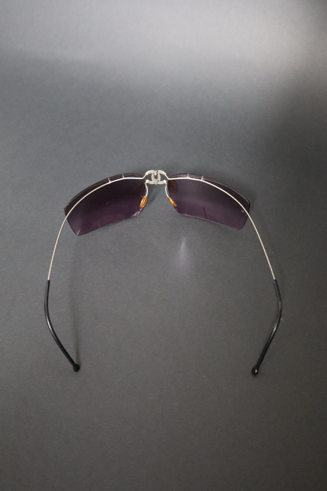 Chanel CC logo folding rimless wrap sunglasses with purple lenses