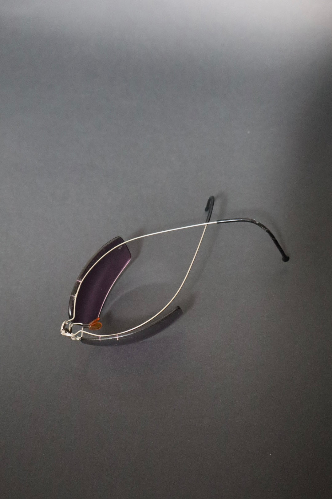 Chanel CC logo folding rimless wrap sunglasses with purple lenses